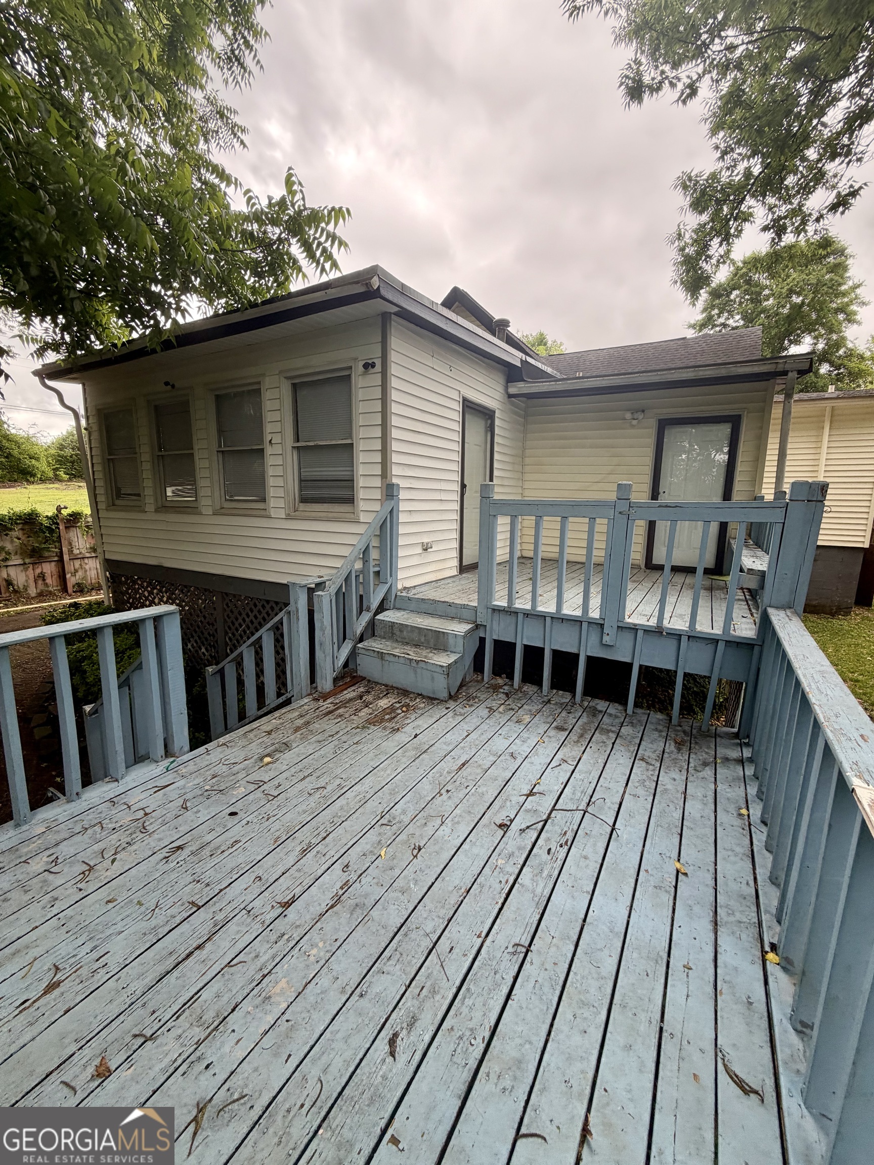 666 Woolfolk Street Macon, GA 31217 - Photo 53 of 60 a view of backyard with deck and wooden floor