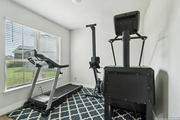 a room with gym equipment and windows