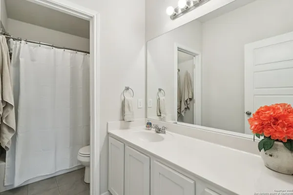 a bathroom with a sink a vanity and a mirror