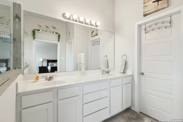 a bathroom with a double vanity sink mirror and