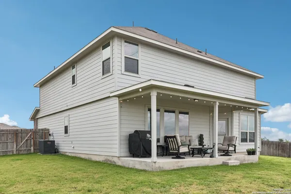 a view of a house with a yard patio and sitting area
