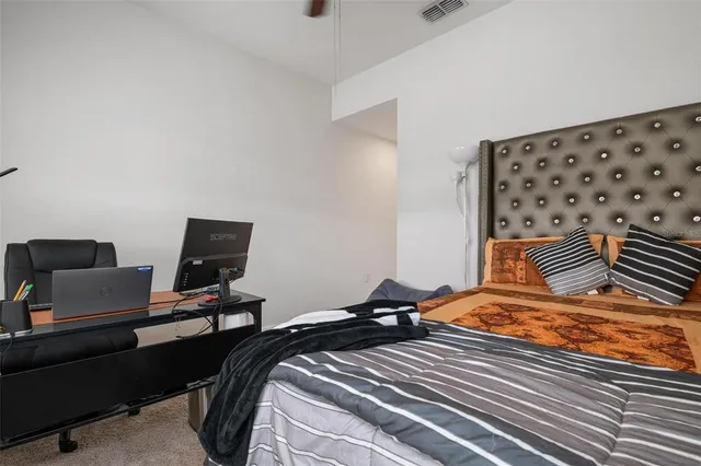 a bedroom with a bed and a desk