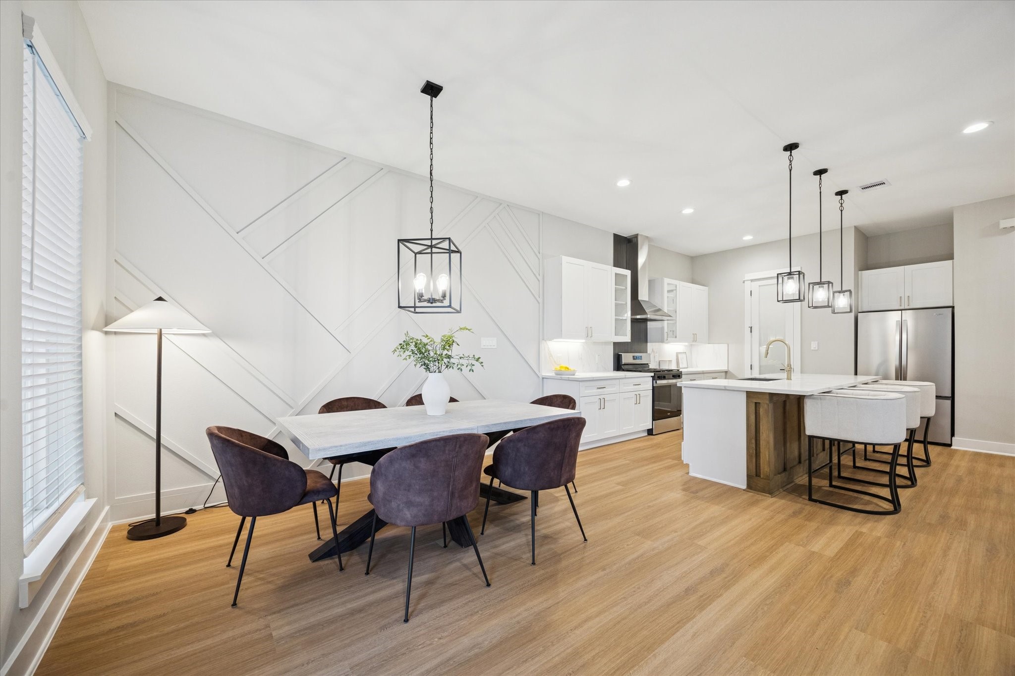719 Thornton Road, Unit C Houston, TX 77018 - Photo 13 of 45 a kitchen with stainless steel appliances kitchen island granite countertop a table chairs in it and wooden floors