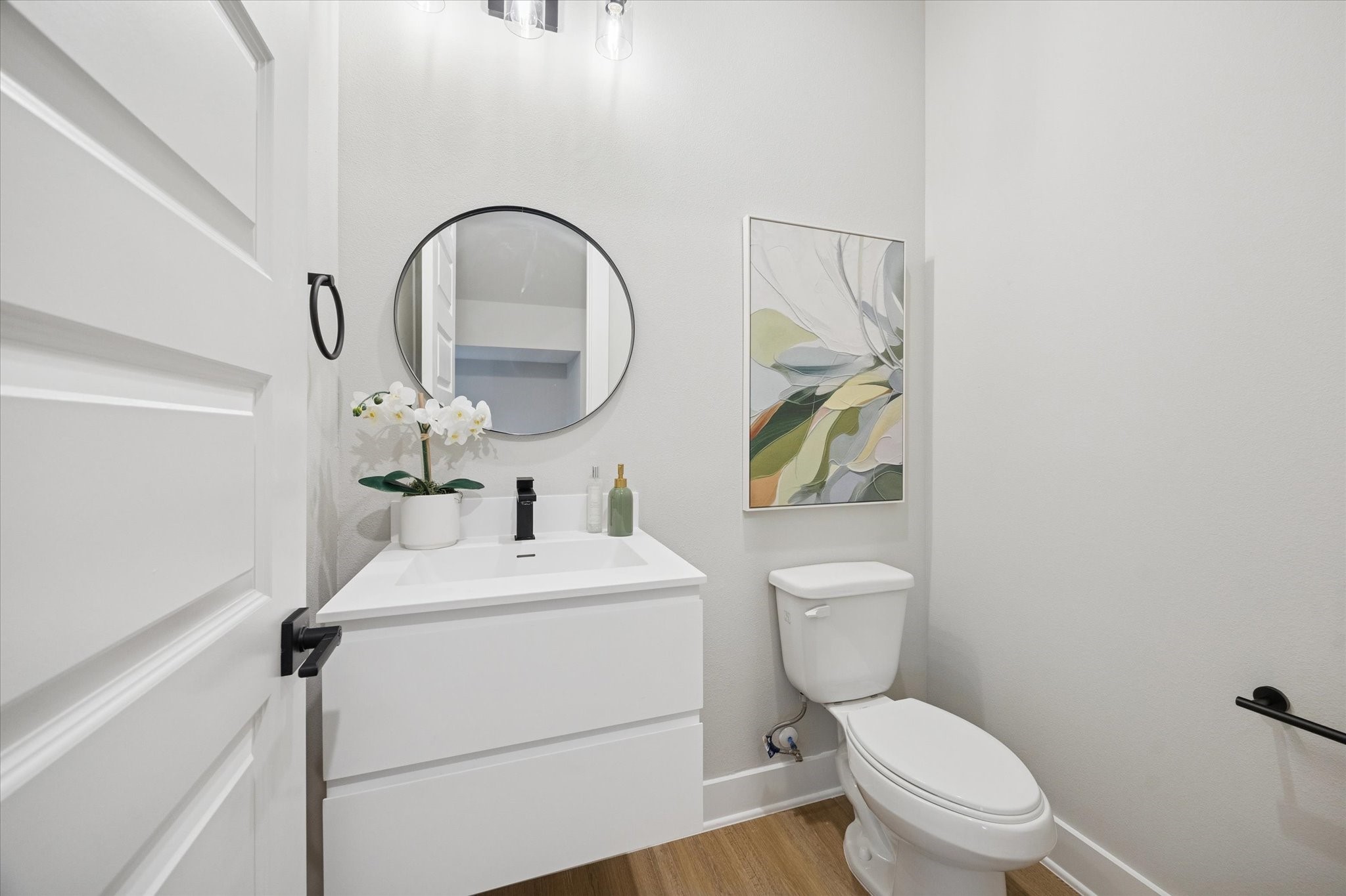 719 Thornton Road, Unit C Houston, TX 77018 - Photo 24 of 45 a bathroom with a toilet sink vanity and mirror