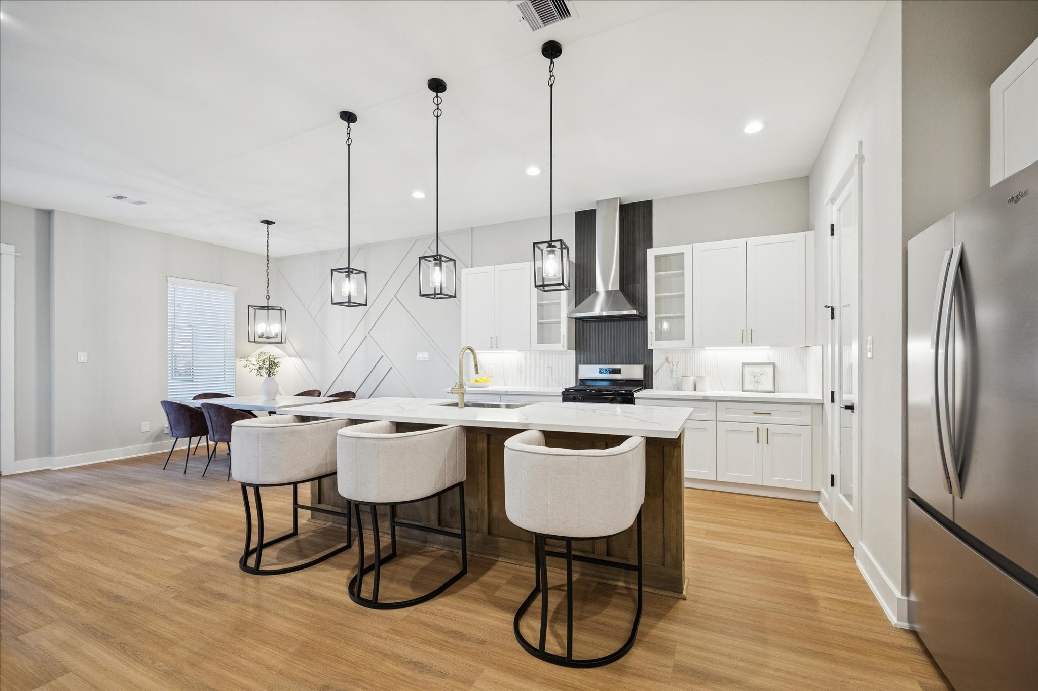 719 Thornton Road, Unit C Houston, TX 77018 - Photo 5 of 45 a kitchen with stainless steel appliances kitchen island a table chairs and a wooden floor