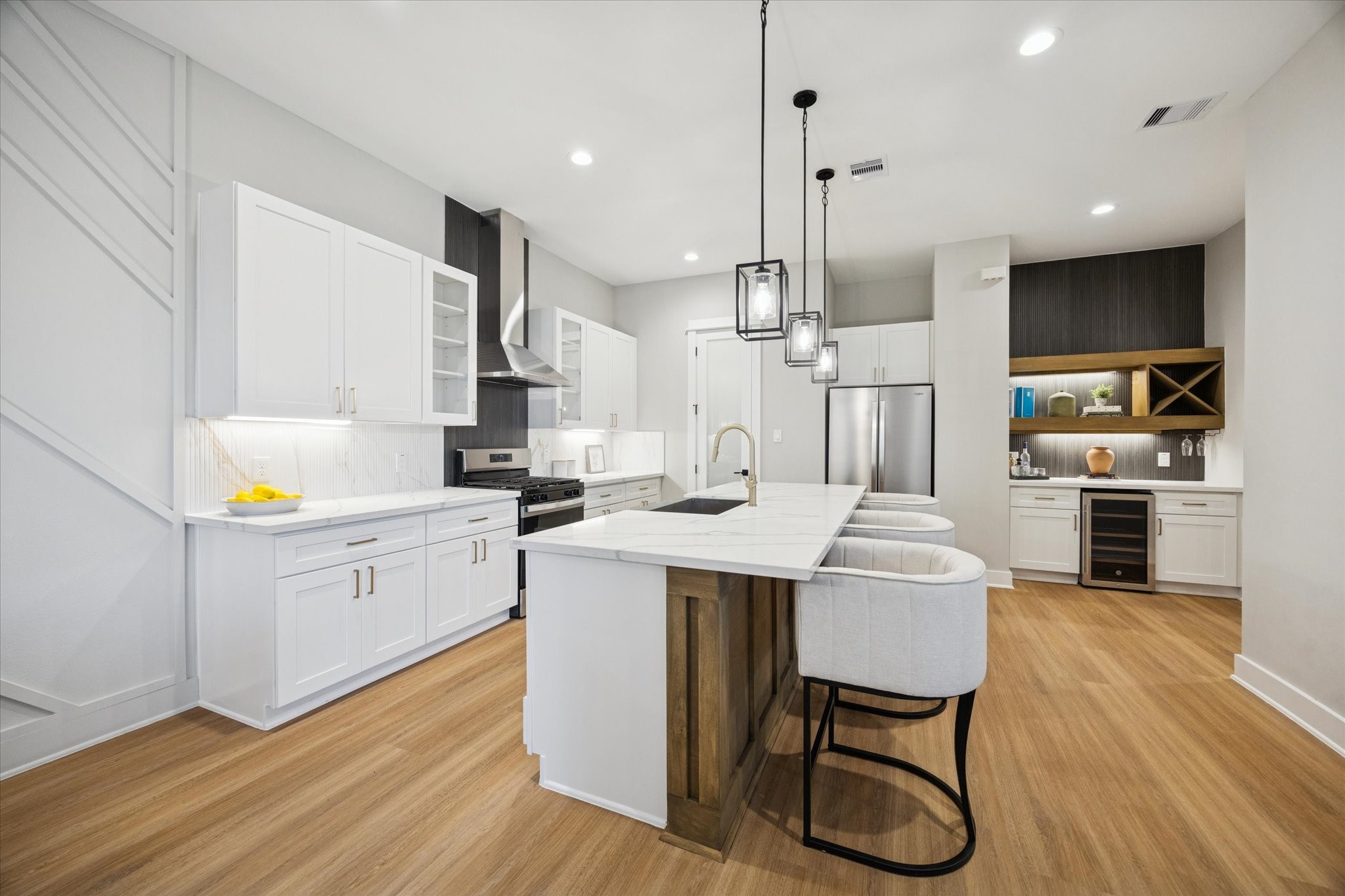719 Thornton Road, Unit C Houston, TX 77018 - Photo 7 of 45 a kitchen with stainless steel appliances kitchen island granite countertop a wooden floor and white cabinets