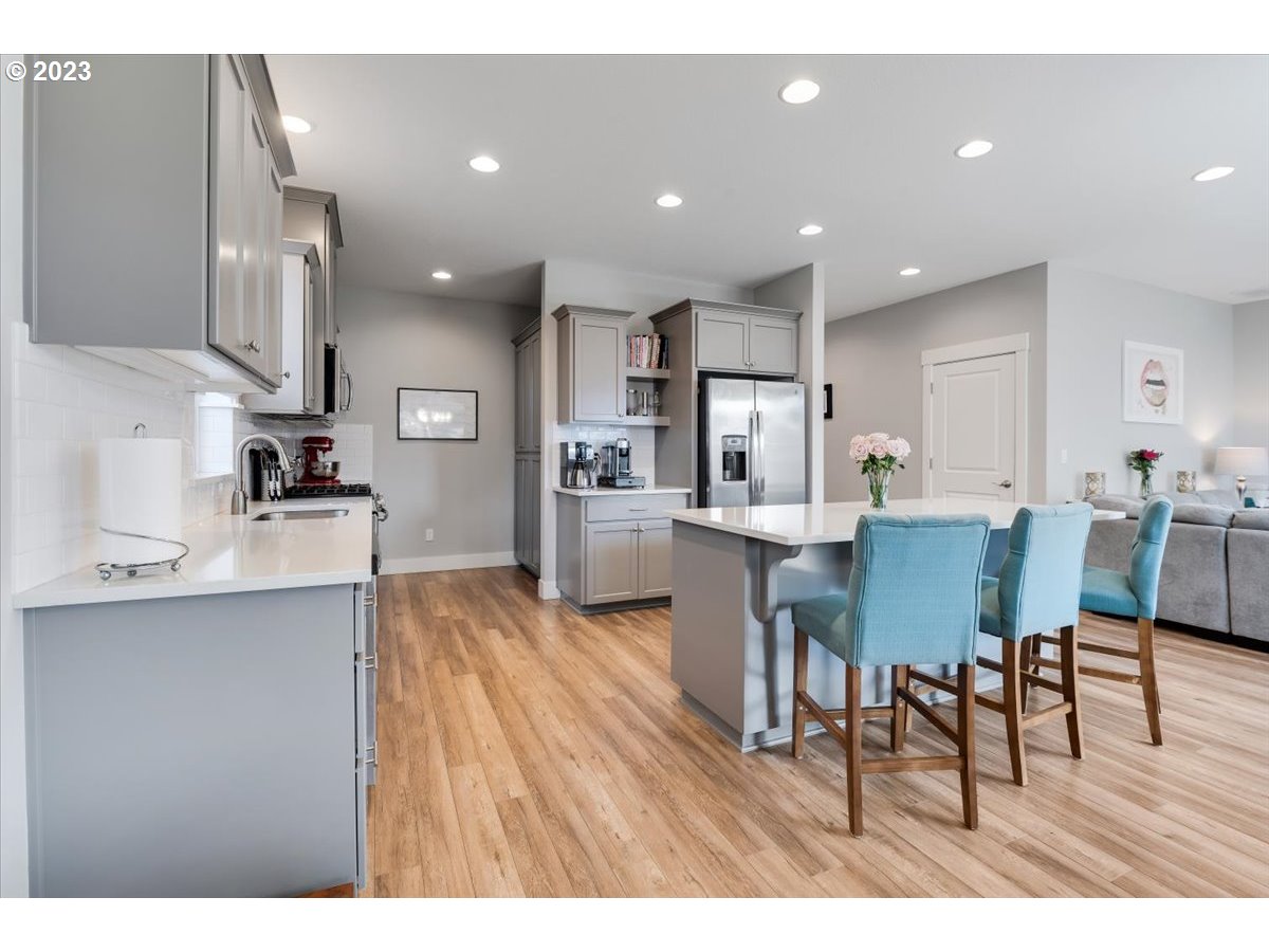 2754 Northwest Inna Avenue Salem, OR 97304 - Photo 11 of 36 a open kitchen view with stainless steel appliances refrigerator dining table and chairs