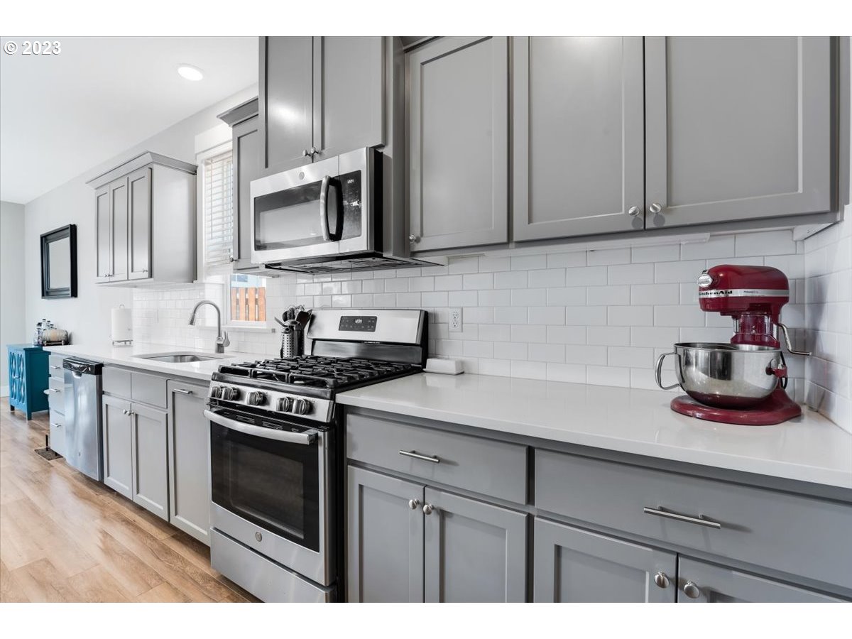 2754 Northwest Inna Avenue Salem, OR 97304 - Photo 14 of 36 a kitchen with stainless steel appliances granite countertop a sink a stove and cabinets