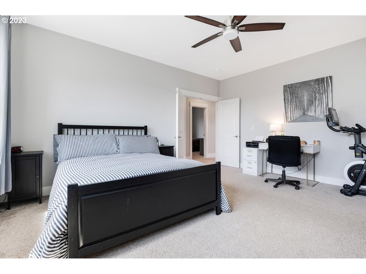 2754 Northwest Inna Avenue Salem, OR 97304 - Photo 17 of 36 a bedroom with a bed and a chandelier