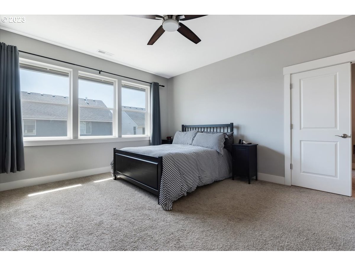 2754 Northwest Inna Avenue Salem, OR 97304 - Photo 19 of 36 a bedroom with a bed and a large window