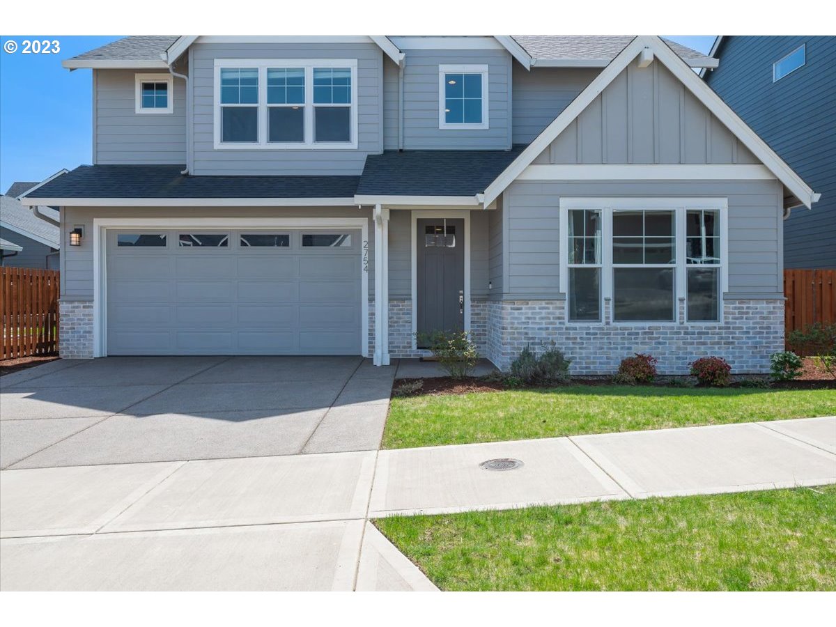 2754 Northwest Inna Avenue Salem, OR 97304 - Photo 2 of 36 a front view of a house with a garden and garage