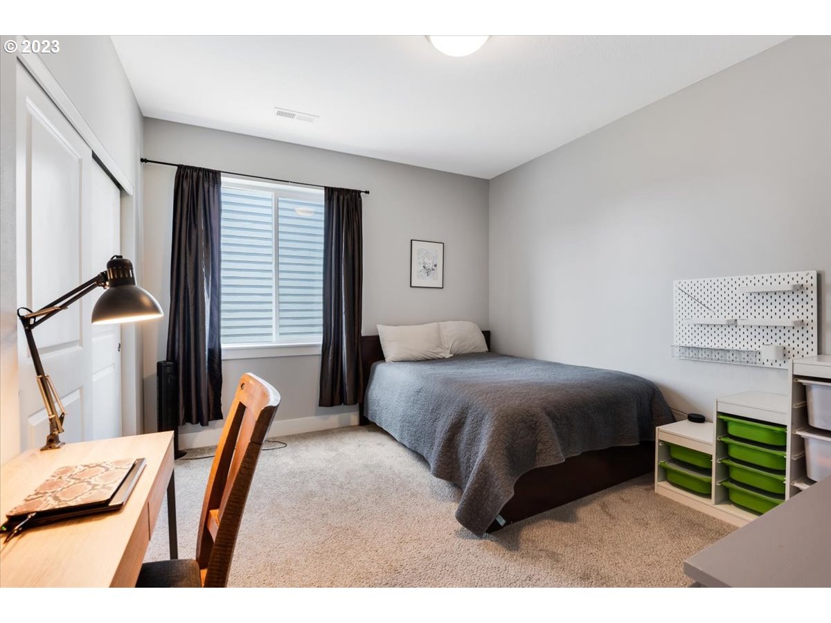 2754 Northwest Inna Avenue Salem, OR 97304 - Photo 25 of 36 a bedroom with a bed a desk and chair