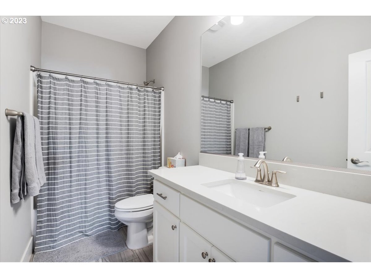 2754 Northwest Inna Avenue Salem, OR 97304 - Photo 27 of 36 a bathroom with a sink a toilet and mirror