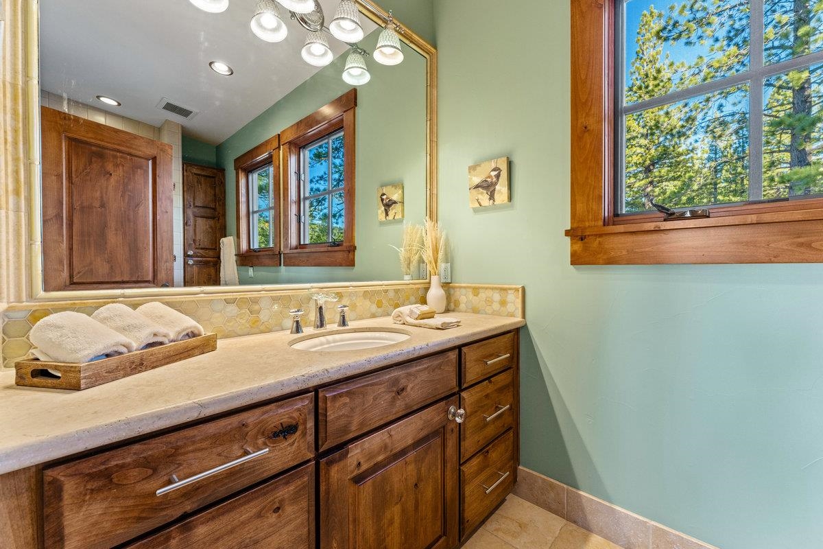 610 Joseph Bernard Truckee, CA 96161 - Photo 16 of 21 a bathroom with a granite countertop sink and a large mirror