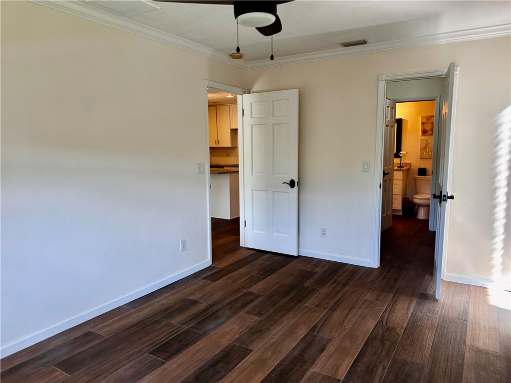 1815 Robalo Drive, Unit C201 Vero Beach, FL 32960 - Photo 18 of 31 a view of empty room with wooden floor and fan