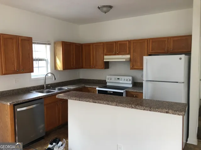 a kitchen with a appliances a sink and a cabinets