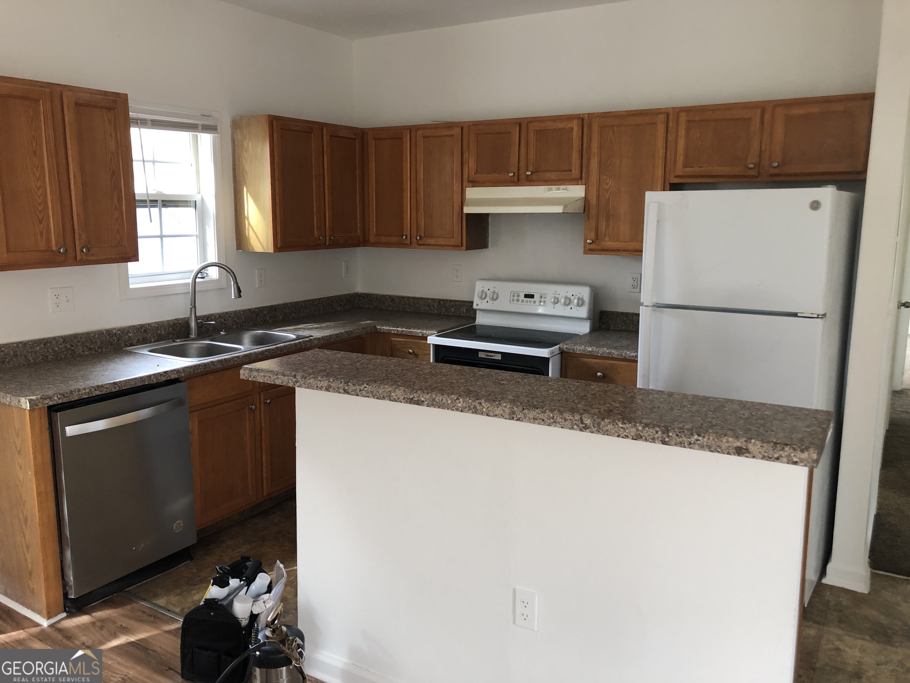 2457 Donald Lee Hollowell Parkway Northwest, Unit A Atlanta, GA 30318 - Photo 10 of 12 a kitchen with granite countertop a sink a stove and a refrigerator