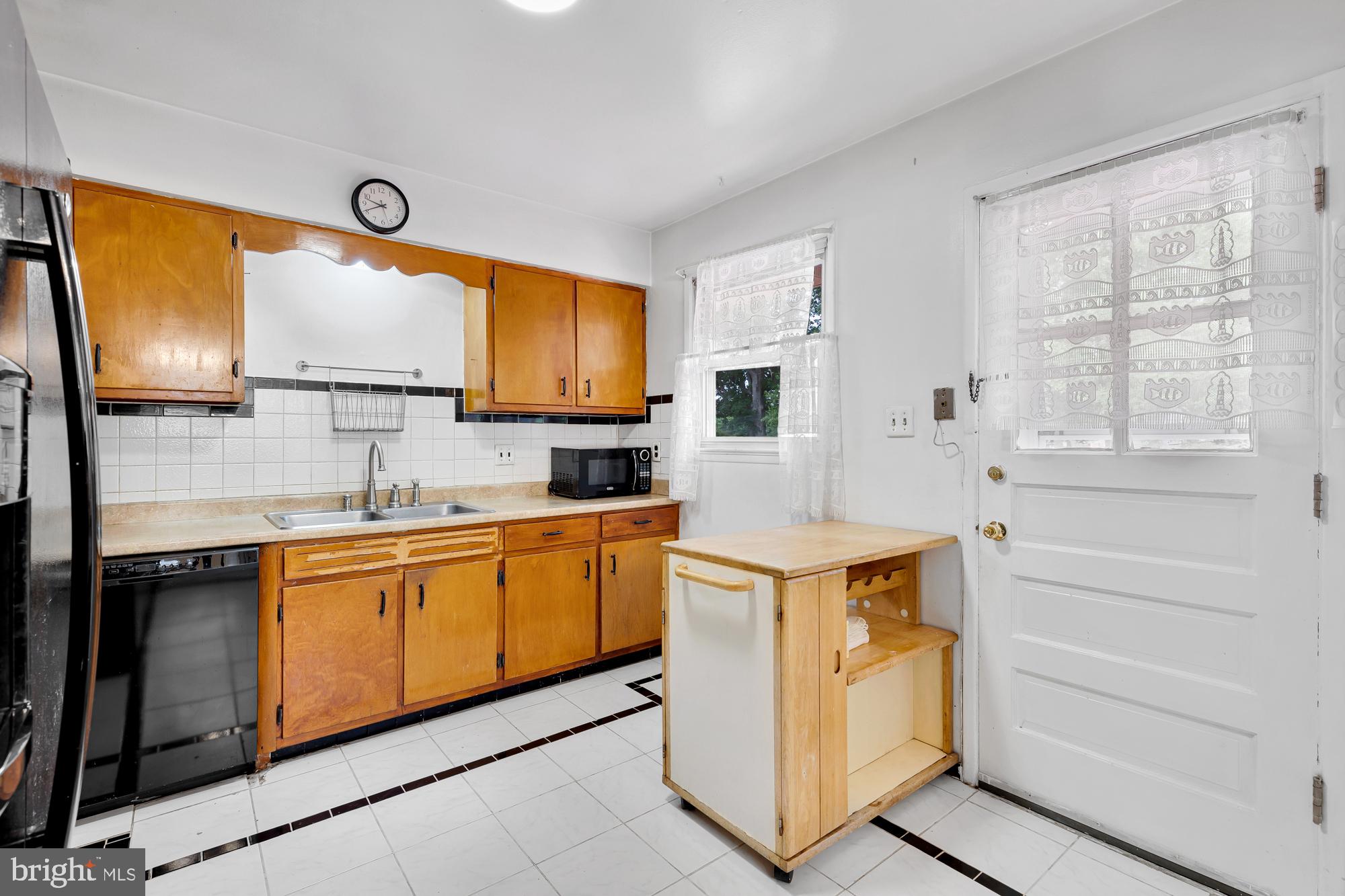 5952 Kedron Street Springfield, VA 22150 - Photo 14 of 39 a kitchen with stainless steel appliances granite countertop a stove a sink and a microwave