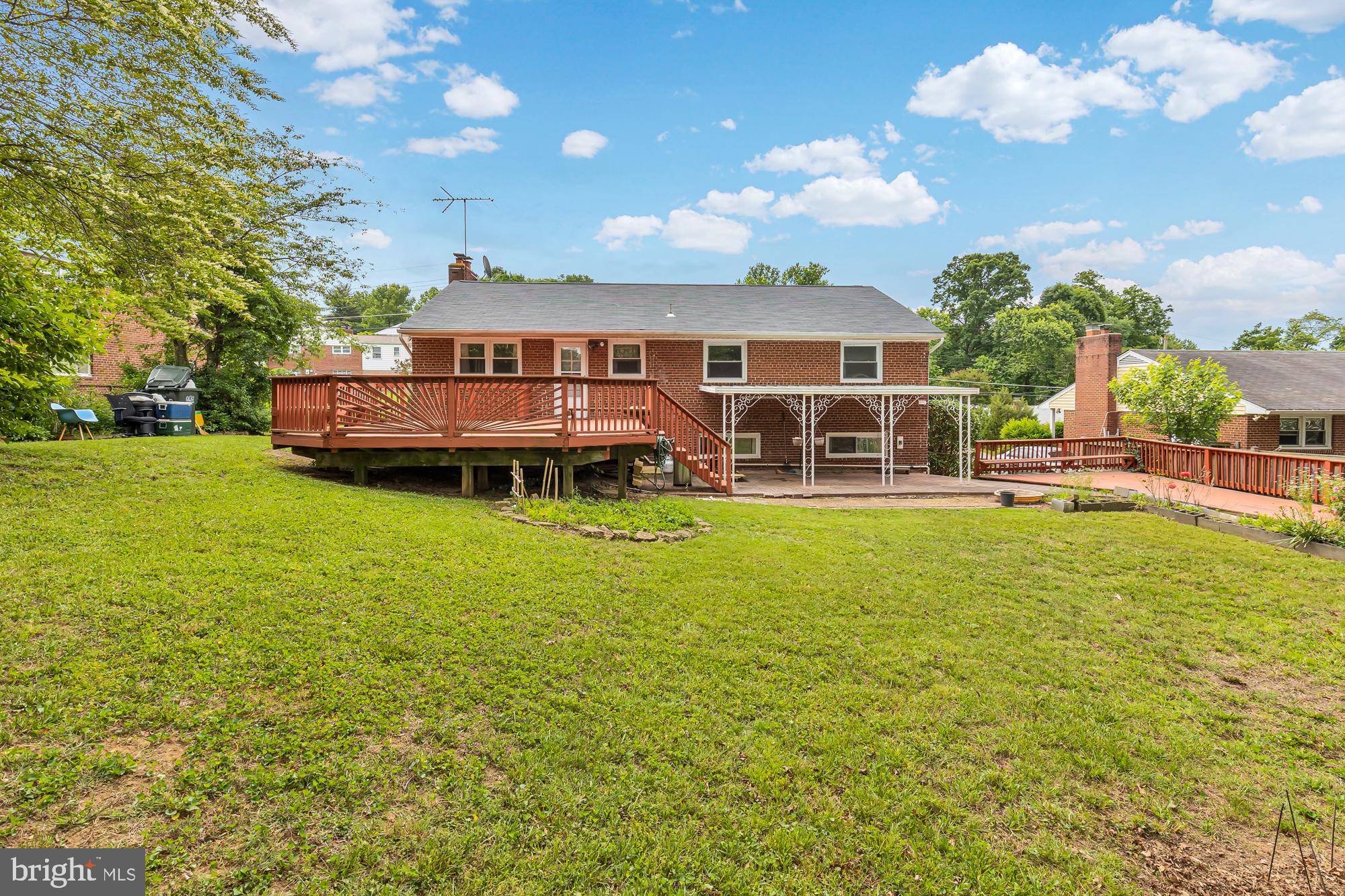 5952 Kedron Street Springfield, VA 22150 - Photo 4 of 39 a view of a house with a big yard and large trees