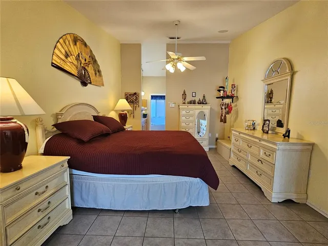 a spacious bedroom with a bed and a table