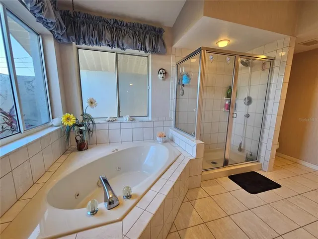 a bathroom with a tub and a shower