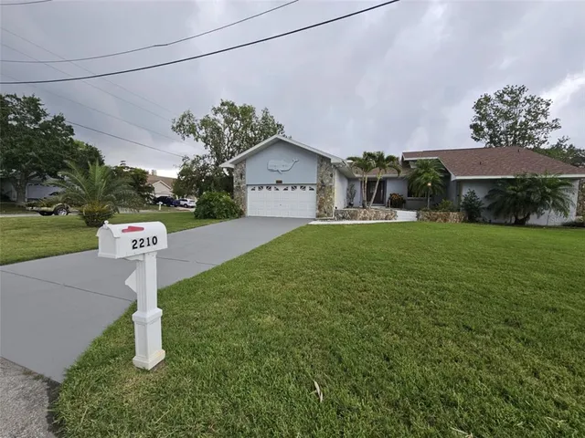 a front view of a house with a yard and garage