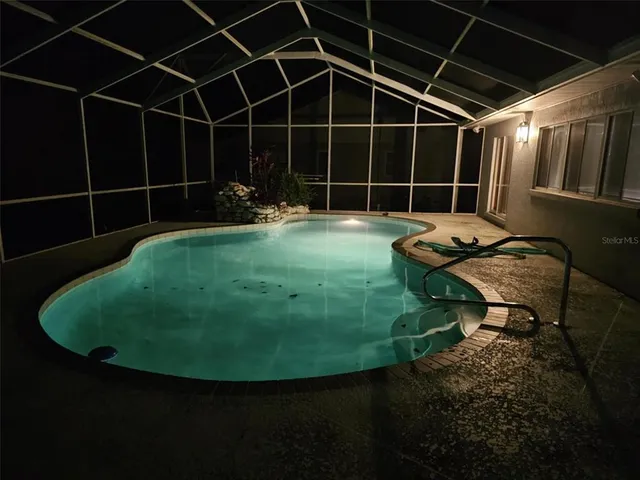 a view of a house with a wooden deck and a trees