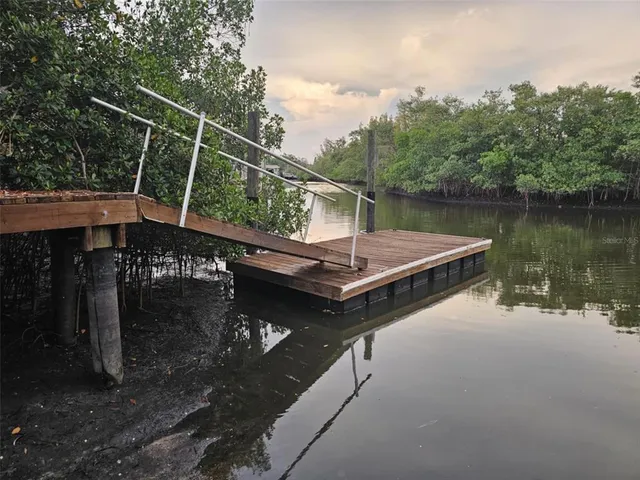 a view of a lake with green landscape