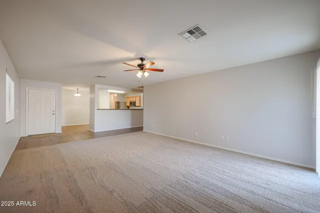 a view of a kitchen with a sink and chandelier fan