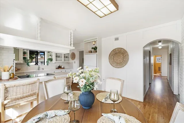 a living room with fireplace furniture and a potted plant