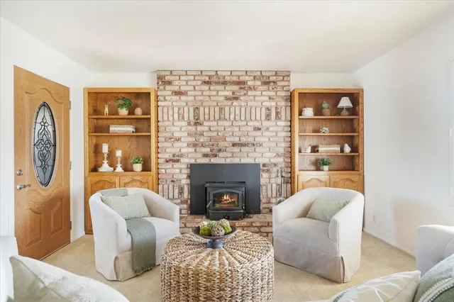 a living room with furniture a lamp and a fireplace