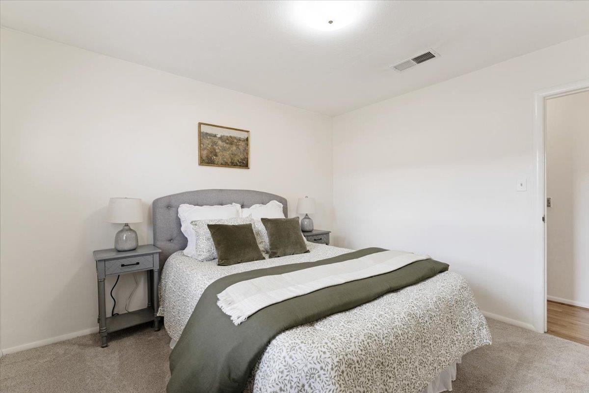 172 West Phillips Road Watsonville, CA 95076 - Photo 19 of 42 a bedroom with a bed and a lamp