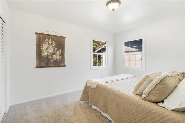 a bedroom with bed and a window