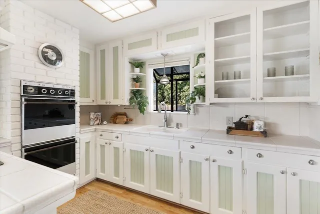 a kitchen with stainless steel appliances a stove microwave and cabinets