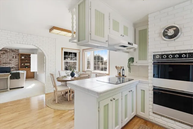a open kitchen with stainless steel appliances granite countertop a stove and a sink