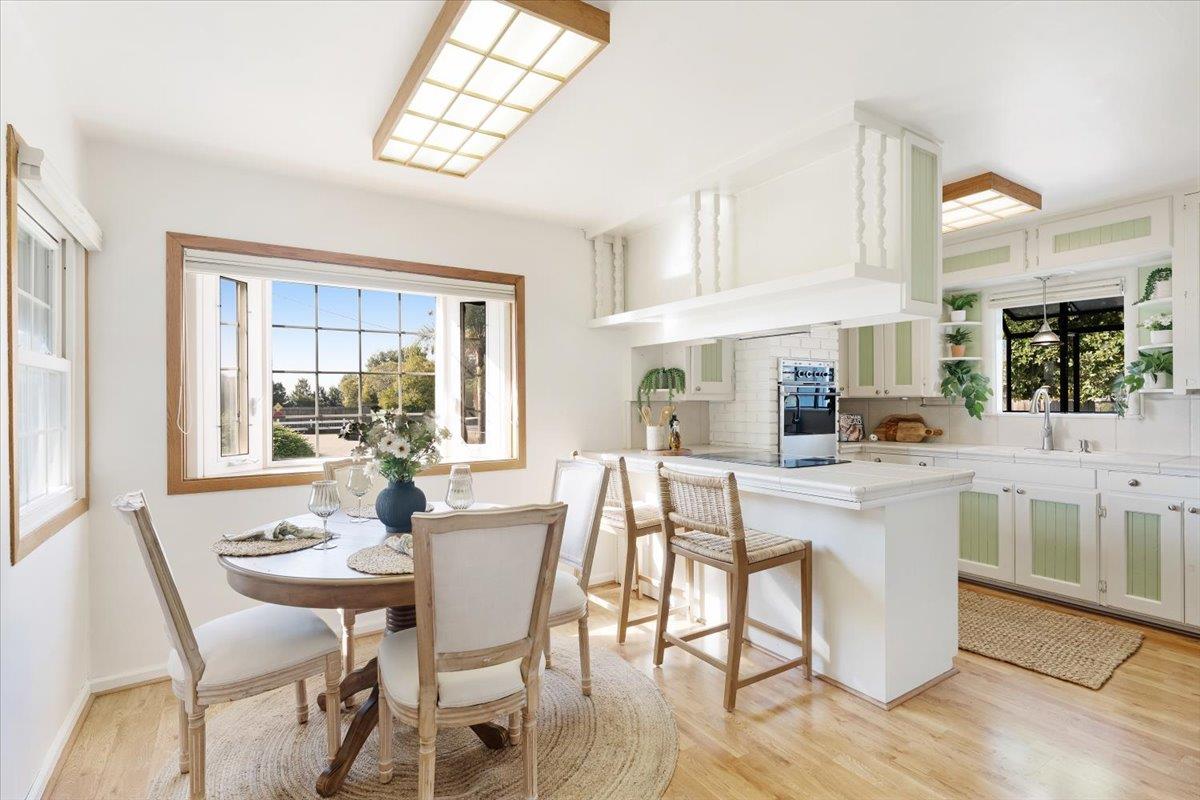 172 West Phillips Road Watsonville, CA 95076 - Photo 9 of 42 a kitchen with a dining table chairs and white cabinets