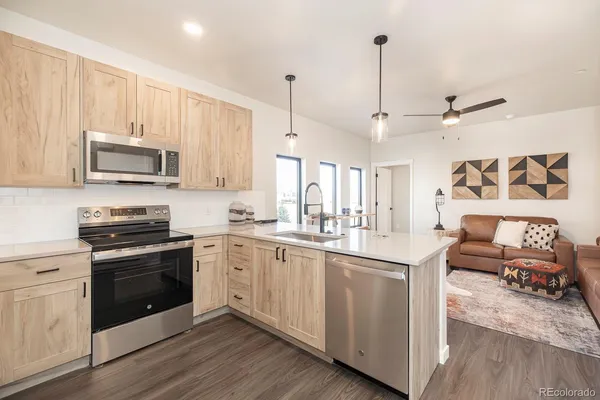 a kitchen with stainless steel appliances granite countertop a stove and a sink