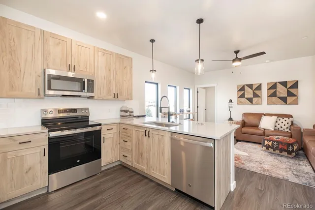 a kitchen with stainless steel appliances granite countertop a stove and a sink