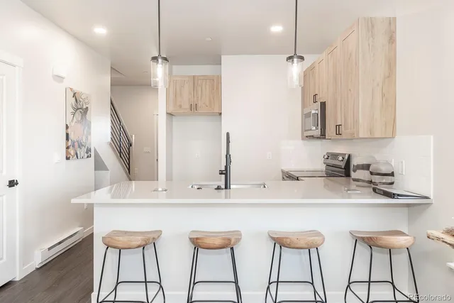 a kitchen with stainless steel appliances kitchen island a chandelier