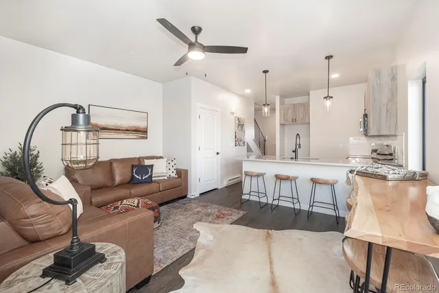 a living room with furniture and a large mirror