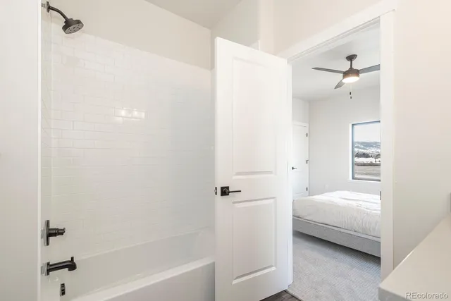 a bedroom with a bed and a large window