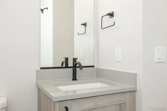 a bathroom with a sink toilet and vanity