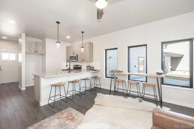 a large white kitchen with lots of counter space and furniture