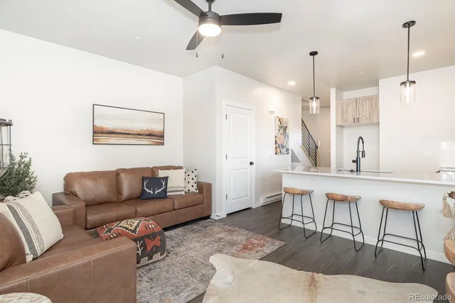a living room with furniture and a wooden floor
