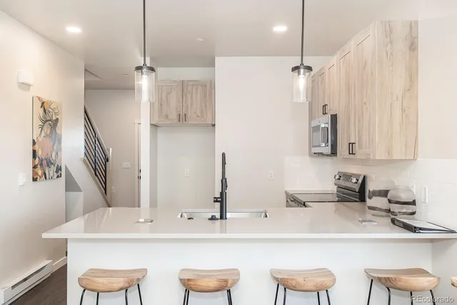 a kitchen with stainless steel appliances a sink and a refrigerator