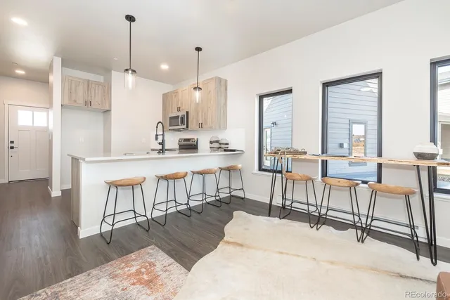 a large kitchen with a table and chairs
