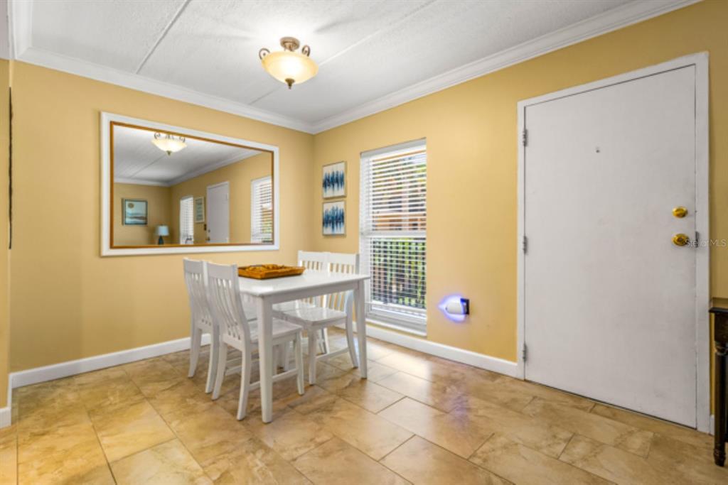 8911 Blind Pass Road, Unit 223 St. Pete Beach, FL 33706 - Photo 18 of 27 a view of a livingroom with furniture and a window
