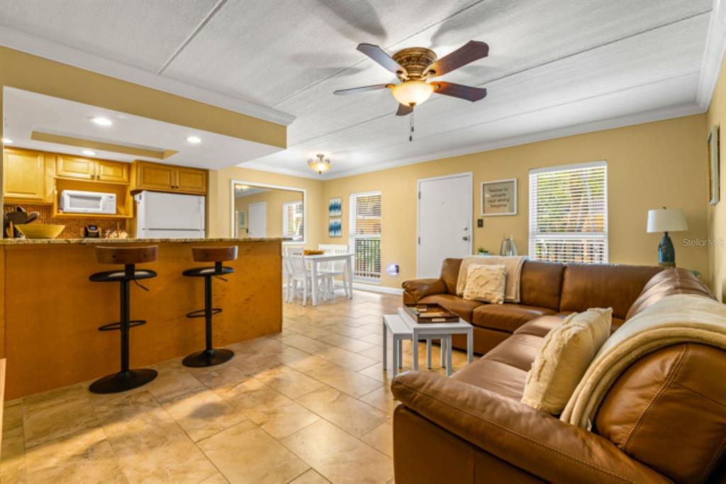 8911 Blind Pass Road, Unit 223 St. Pete Beach, FL 33706 - Photo 3 of 27 a living room with furniture and a large window