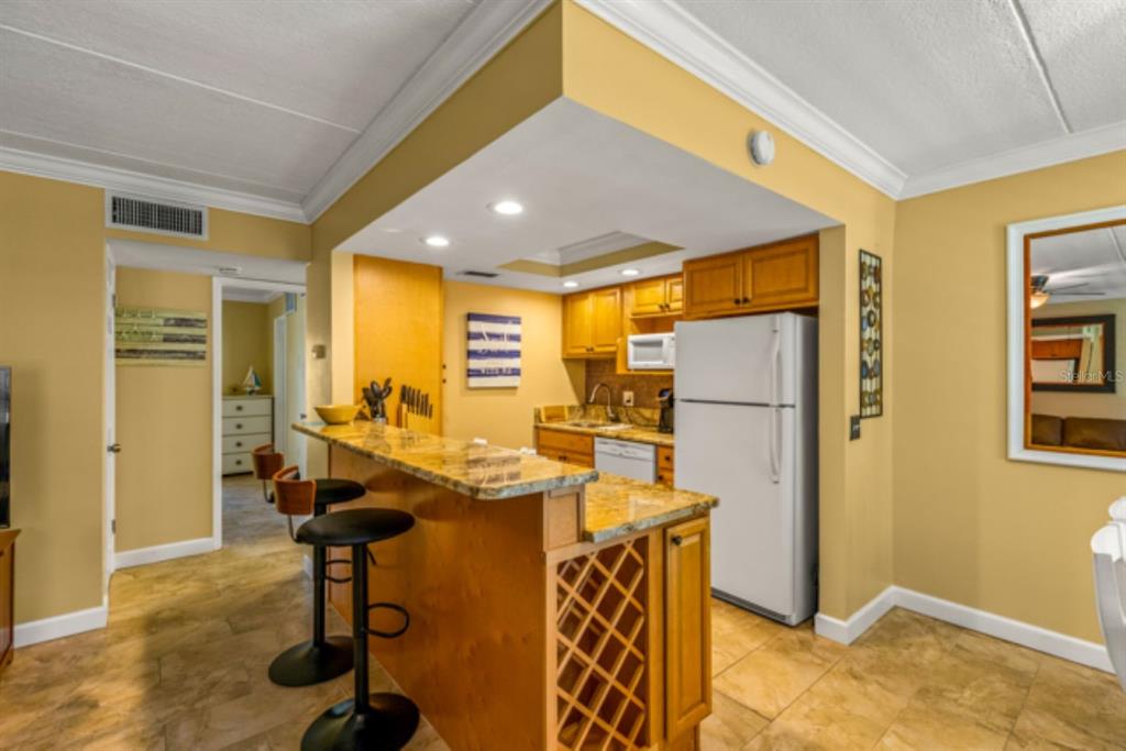 8911 Blind Pass Road, Unit 223 St. Pete Beach, FL 33706 - Photo 5 of 27 a view of a livingroom with furniture and a window