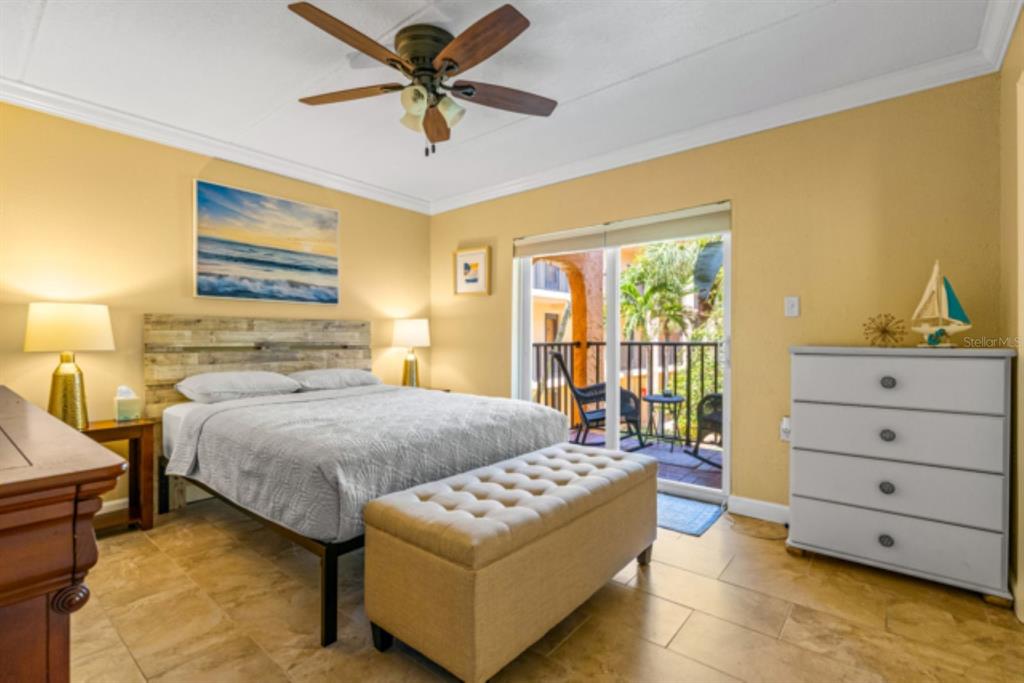8911 Blind Pass Road, Unit 223 St. Pete Beach, FL 33706 - Photo 8 of 27 a bedroom with a bed and a window